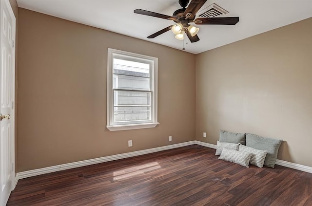 unfurnished room with ceiling fan and dark wood-type flooring