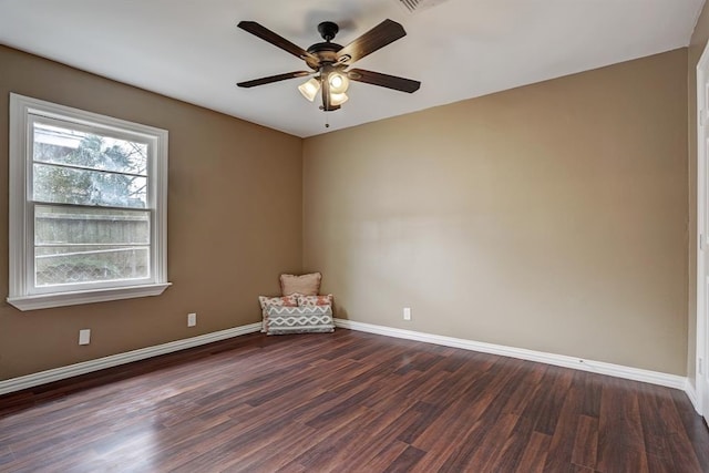 spare room with dark hardwood / wood-style floors and ceiling fan