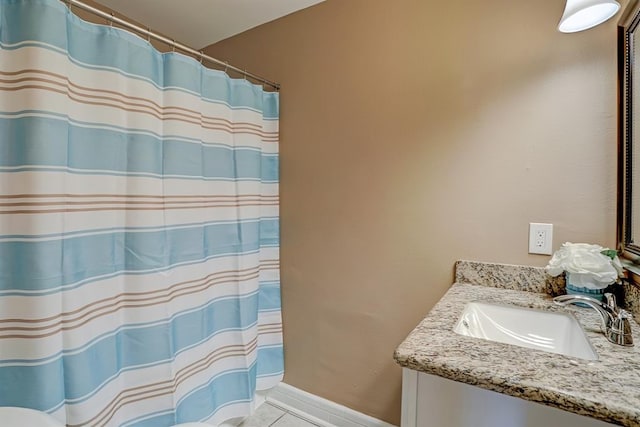 bathroom featuring tile patterned flooring and vanity