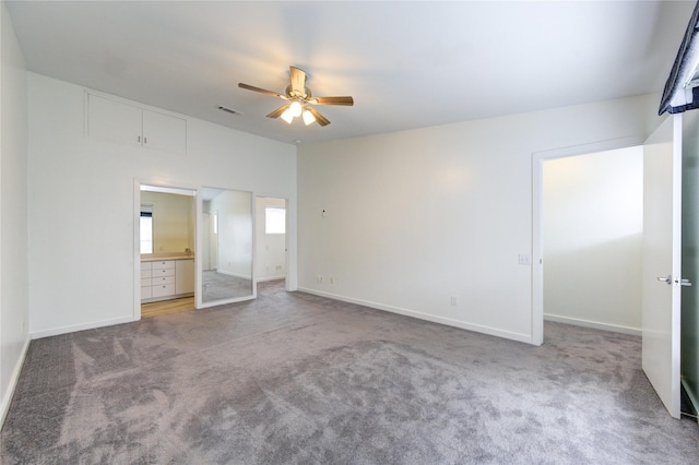 unfurnished bedroom featuring connected bathroom, ceiling fan, a closet, and carpet