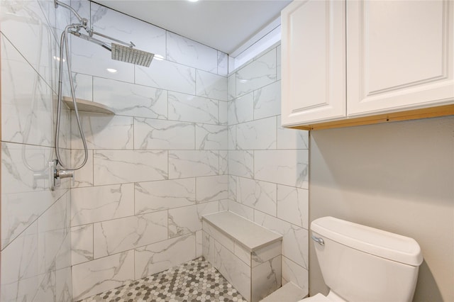 bathroom with toilet and tiled shower