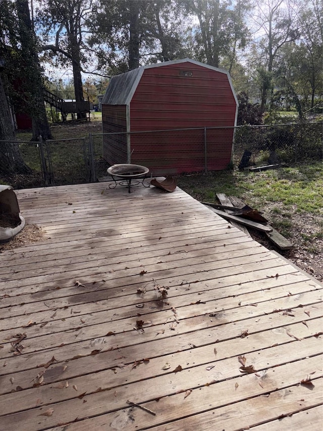 wooden terrace with a shed