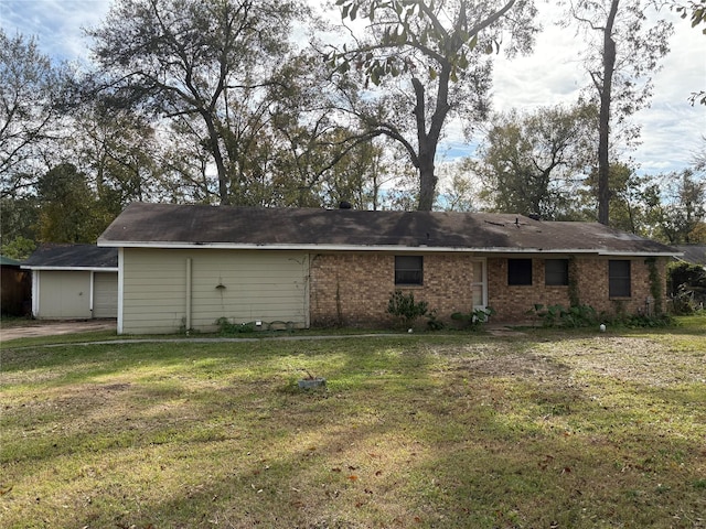 back of house with a lawn