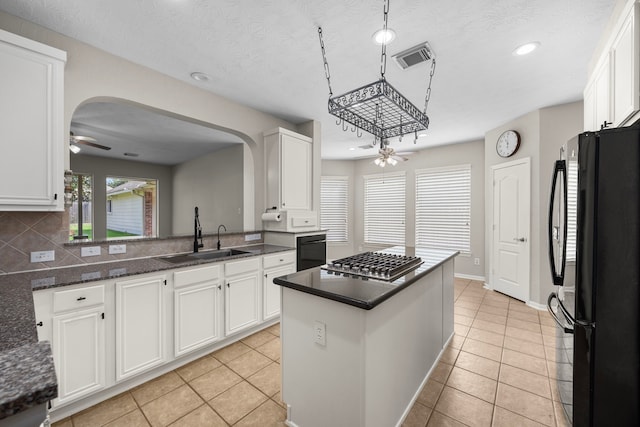 kitchen with white cabinetry, sink, ceiling fan, backsplash, and black appliances