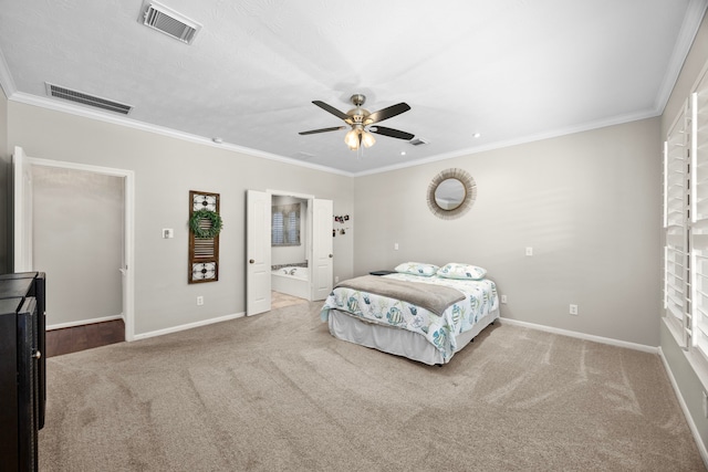 carpeted bedroom featuring ceiling fan, crown molding, and ensuite bath