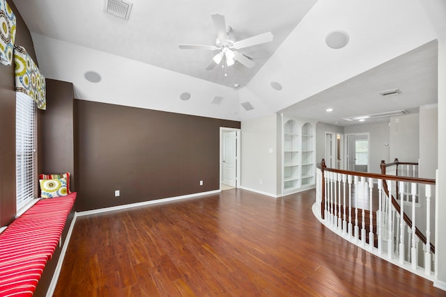 empty room featuring ceiling fan, dark hardwood / wood-style flooring, and vaulted ceiling