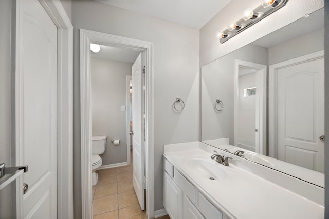 bathroom featuring tile patterned floors, vanity, and toilet