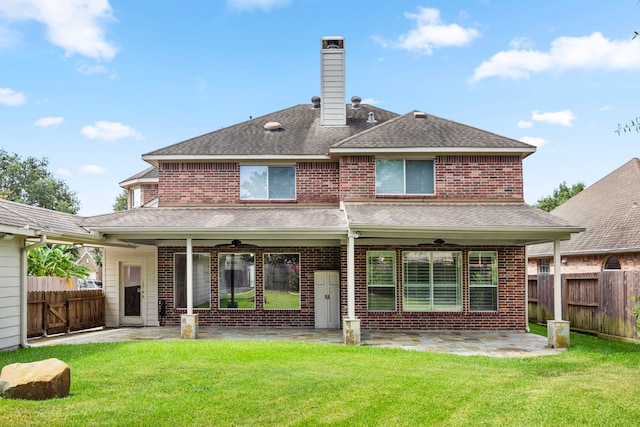 back of house with a yard, a patio, and ceiling fan