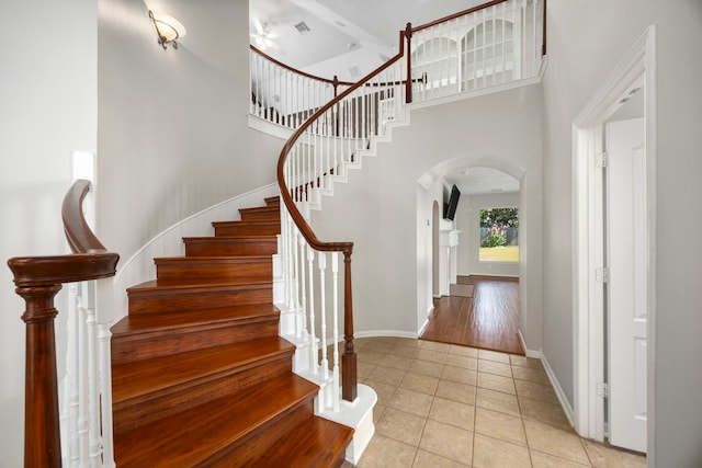 foyer with a high ceiling and light tile patterned floors