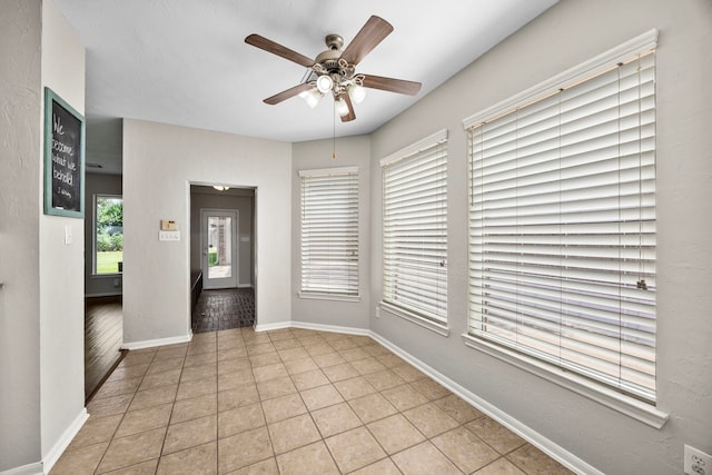 unfurnished room featuring light tile patterned floors and ceiling fan