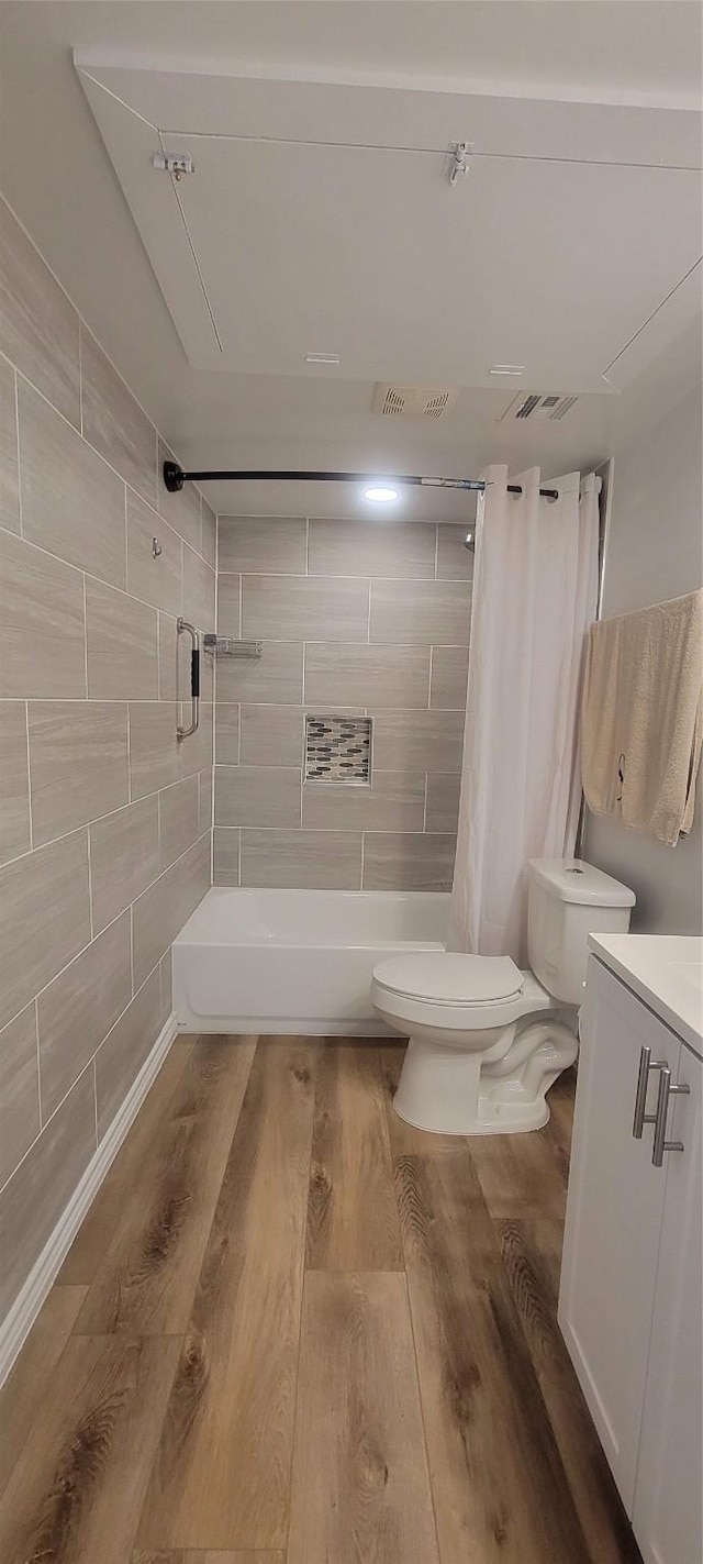 bathroom featuring toilet, vanity, wood-type flooring, and walk in shower