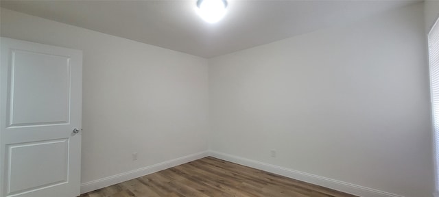 unfurnished room with hardwood / wood-style floors