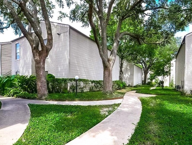 view of side of home with a yard