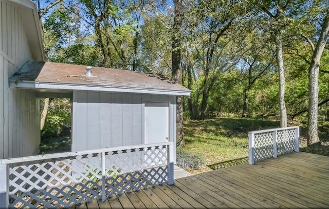 wooden terrace featuring a yard