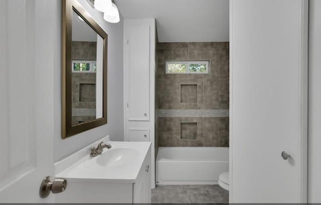 full bathroom with tile patterned floors, vanity, toilet, and tiled shower / bath