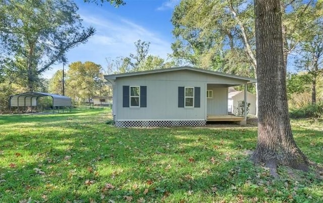 exterior space featuring a lawn and a carport