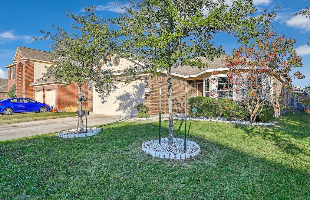 view of front of property with a garage and a front lawn