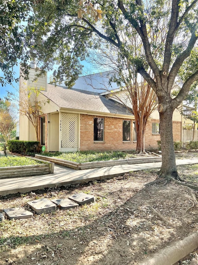 7854 Green Lawn Dr Unit 7854, Houston, TX 77088 - view of front of property with brick siding, a chimney, and a shingled roof