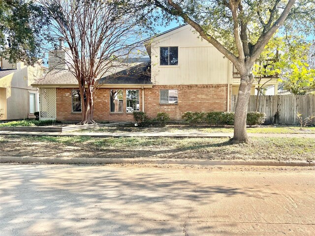 7854 Green Lawn Dr Unit 7854, Houston, TX 77088 - traditional-style house with brick siding and a chimney