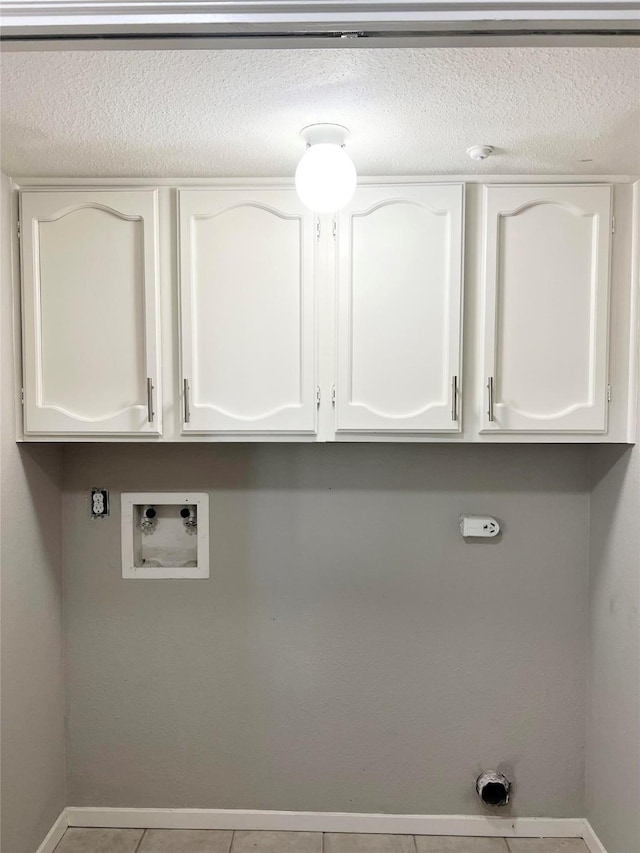 7854 Green Lawn Dr Unit 7854, Houston, TX 77088 - washroom featuring cabinet space, hookup for a washing machine, a textured ceiling, gas dryer hookup, and tile patterned floors