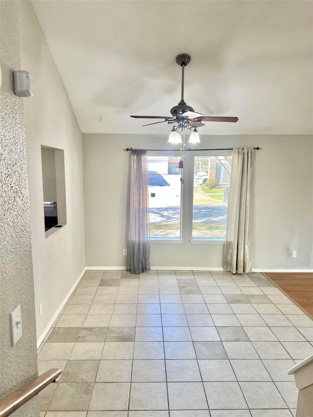 tiled empty room with ceiling fan