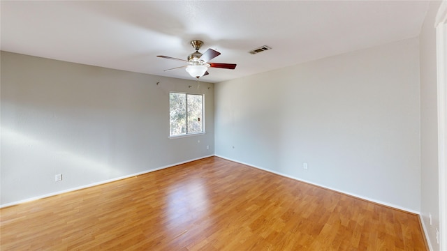 spare room featuring light wood-type flooring and ceiling fan