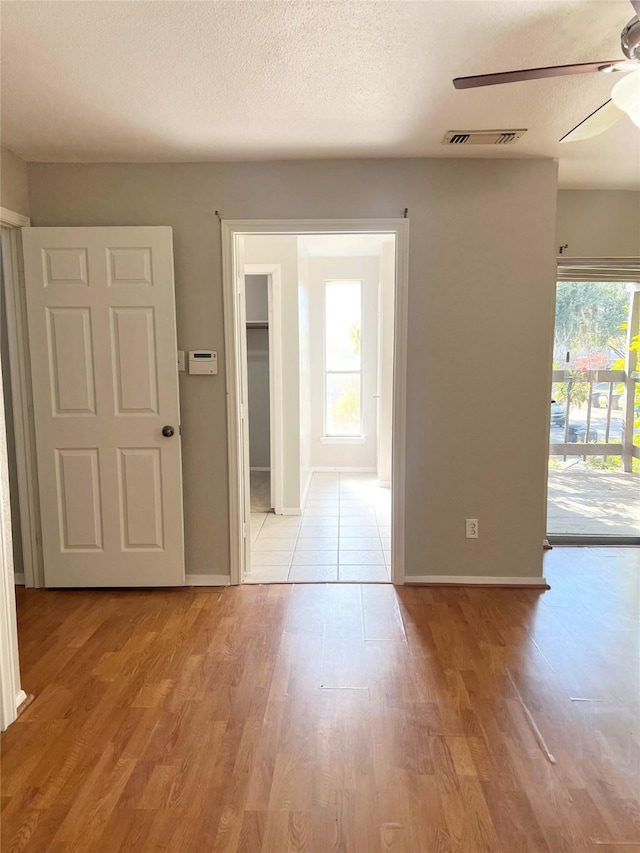 7854 Green Lawn Dr Unit 7854, Houston, TX 77088 - spare room with a ceiling fan, plenty of natural light, and light wood-style floors
