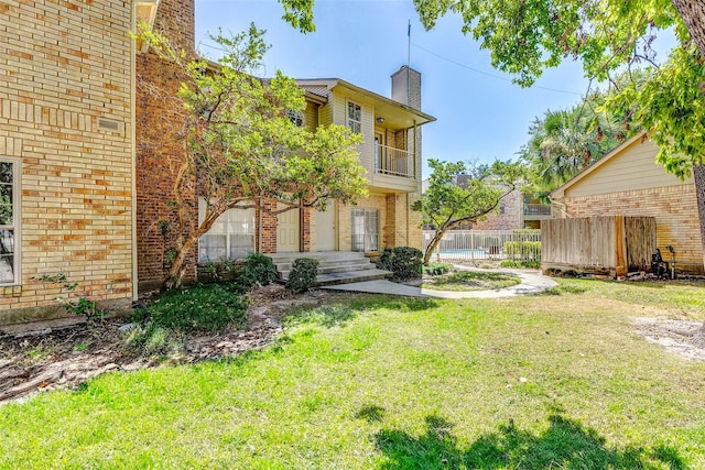 view of yard with a balcony