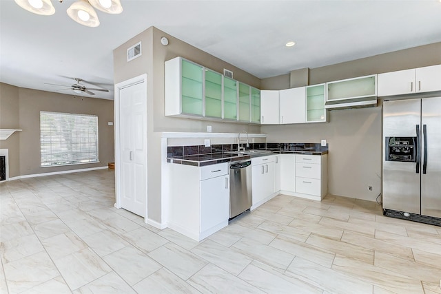 kitchen featuring stainless steel appliances, white cabinetry, ceiling fan, and sink