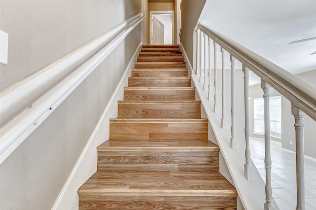 stairs featuring hardwood / wood-style flooring