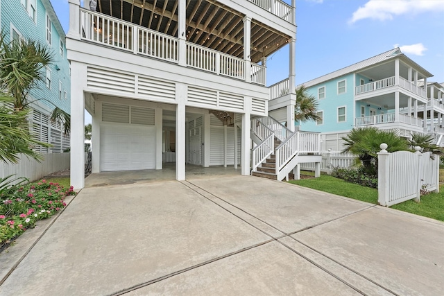 exterior space with a carport, a garage, and fence