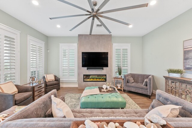 living room featuring a fireplace, light hardwood / wood-style floors, and plenty of natural light