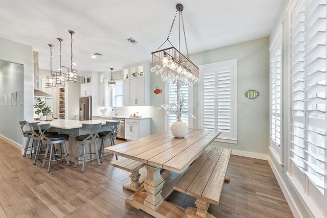 dining room featuring hardwood / wood-style floors and sink