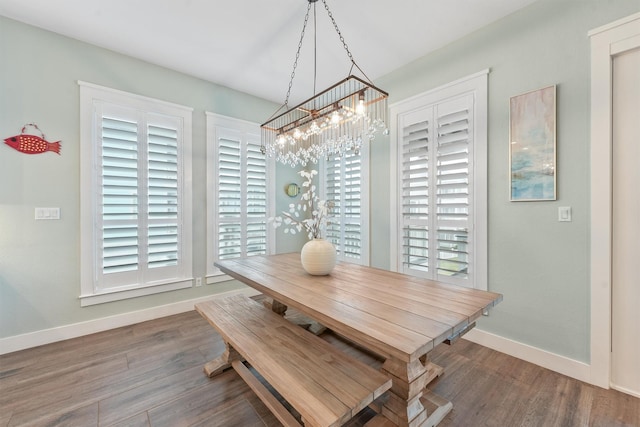 dining space featuring baseboards and wood finished floors