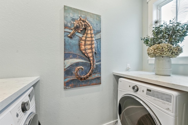 laundry area with washing machine and clothes dryer