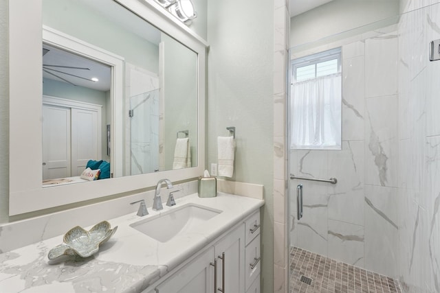 full bathroom with vanity and a marble finish shower