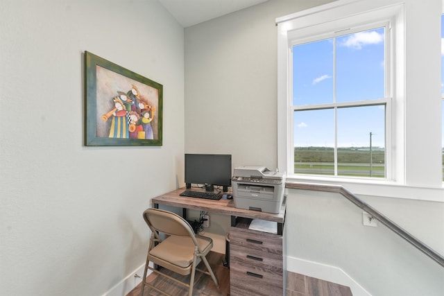 home office with wood finished floors and baseboards