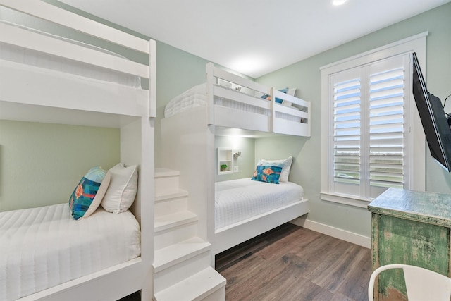 bedroom with baseboards and wood finished floors