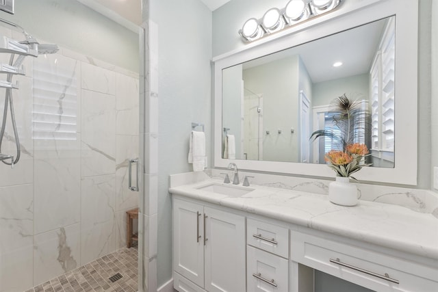 full bathroom featuring a stall shower and vanity