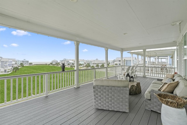 wooden deck with a residential view, an outdoor hangout area, and a yard