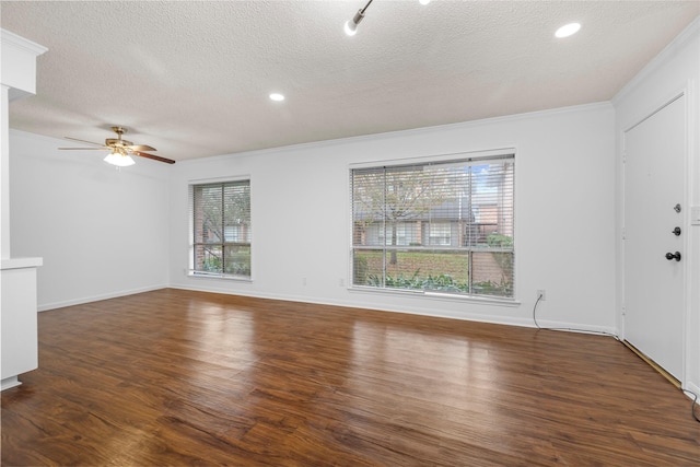 unfurnished living room with ceiling fan, dark hardwood / wood-style flooring, a textured ceiling, and ornamental molding