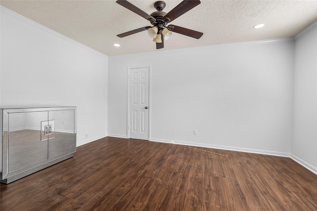 empty room featuring crown molding, ceiling fan, dark wood-type flooring, and a textured ceiling