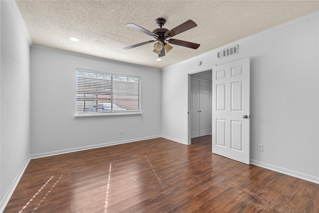 empty room with a textured ceiling, dark hardwood / wood-style floors, ceiling fan, and crown molding