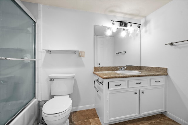 full bathroom featuring tile patterned floors, vanity, toilet, and bath / shower combo with glass door