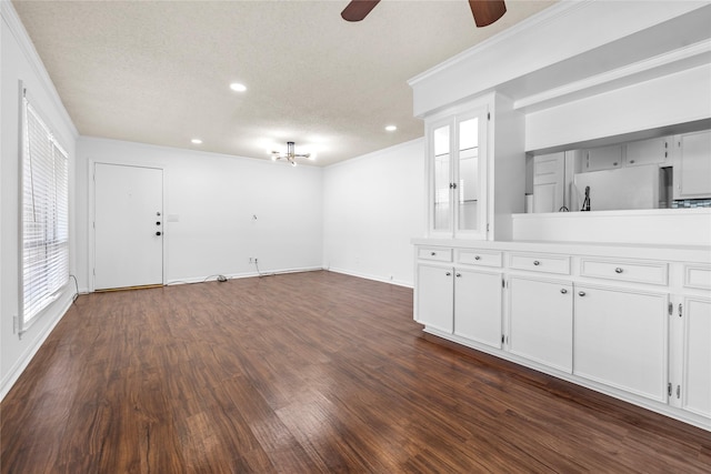 interior space with crown molding, dark hardwood / wood-style flooring, and a textured ceiling