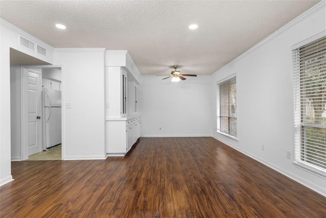 unfurnished living room featuring dark hardwood / wood-style floors, ceiling fan, ornamental molding, and a textured ceiling