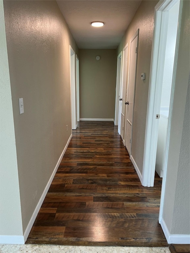 corridor featuring dark hardwood / wood-style floors