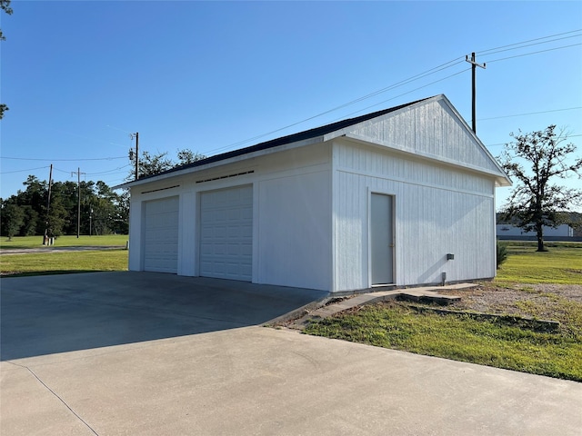 garage featuring a lawn