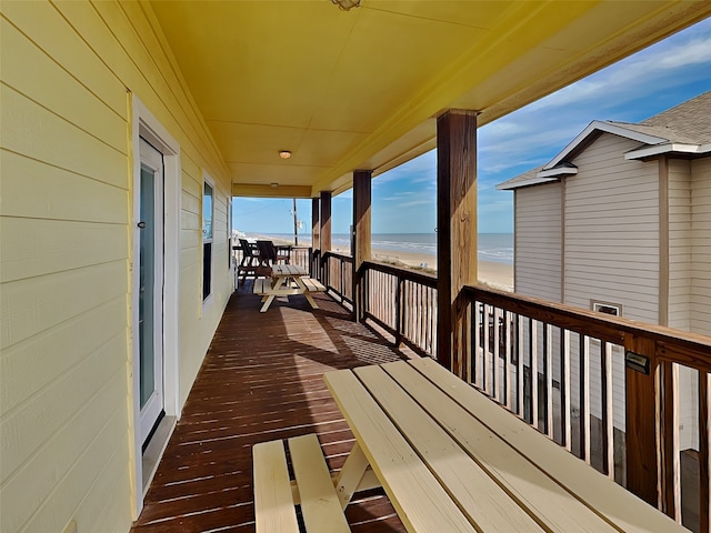 deck with a water view and a view of the beach