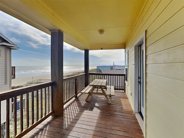 deck with a water view and a beach view